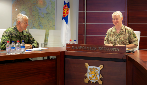 Commanders discussing in the conference room.